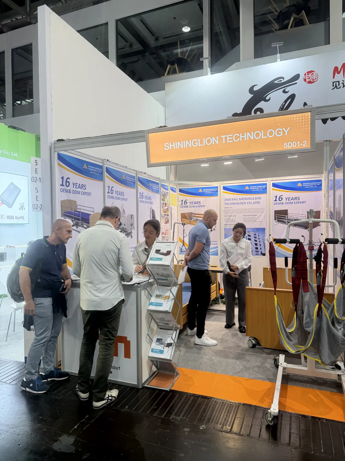 Visitors discussing SHLION care solutions at REHACARE 2026